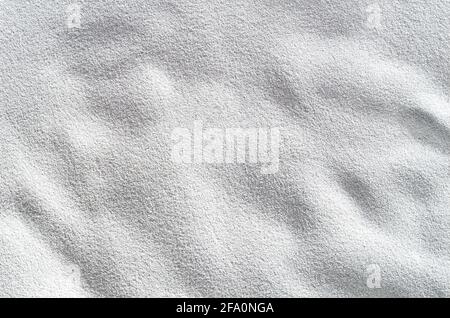 A flat background of coarse ground pumice, lit to show maximum texture. Stock Photo