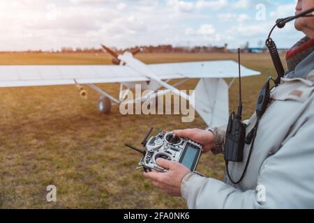 close up pilot hand with remote control joystick for agricultural spraying plane Stock Photo