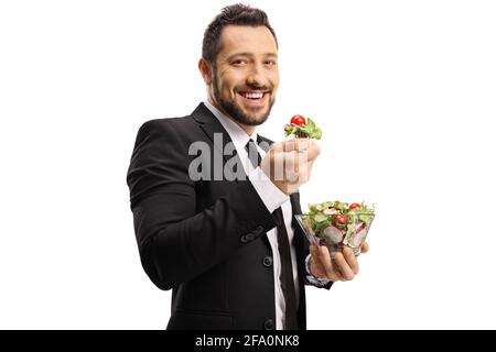Businessman standing and eating a salad isolated on white background Stock Photo