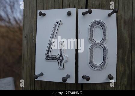 Closeup shot of number "48" nailed on a wooden surface Stock Photo