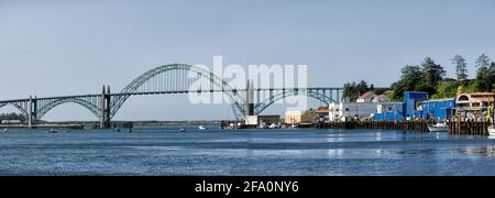 A panorama image of the fishing wharf, and Newport bridge over the Yaquina river in Newport Oregon.. Stock Photo
