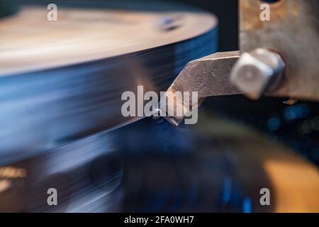Heavy machine building plant Vostokmashzavod.Ust-Kamenogorsk,KZ. Close-up of metal machining on turning lathe.Tool in focus,blank is motion-blurred. Stock Photo