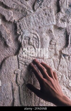 Man's hand on Mayan bas-relief, Chichen Itza, Mexico Stock Photo
