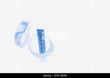 Empty Covid-19 vaccine vial on white translucent background Stock Photo
