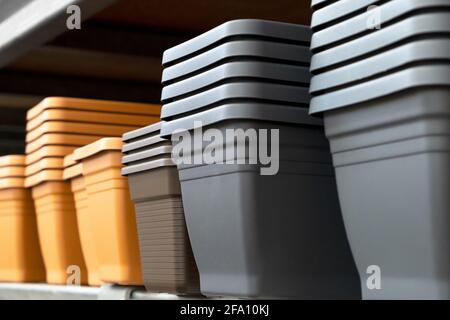 Empty garden Plastic Pots in a row close on the metal shelf in hardware store. Spring Gardening concept Stock Photo