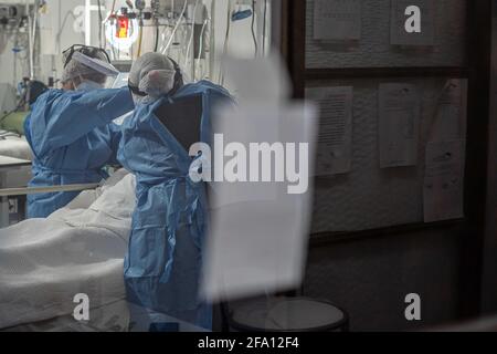 Nurses check on a COVID-19 patient inside San Martin Hospital ICU.With roughly 50% occupation, things do not look bad yet in the country, but Argentina's healthcare system is close to collapse as the second wave of COVID-19 hits. Stock Photo