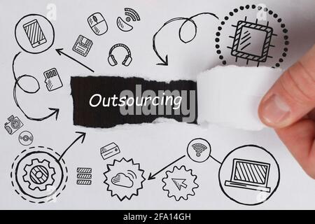 Business, Technology, Internet and network concept. Young businessman working on a virtual screen of the future and sees the inscription: Outsourcing Stock Photo
