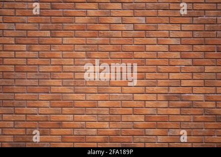 The wall is made of red brick. Background texture of brickwork. Stock Photo