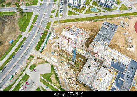 crane on construction site of new building in residential area. top view from drone Stock Photo