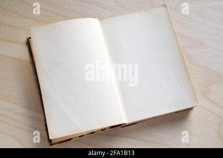 Old vintage book on wooden table. Open book with blank pages Stock Photo