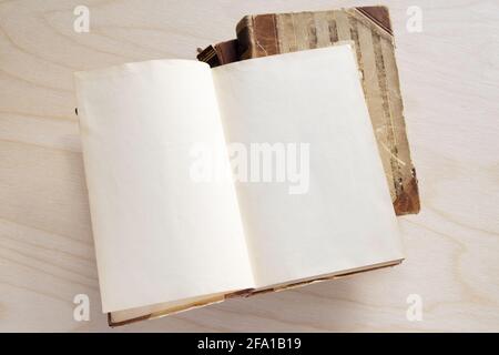 Old vintage book on wooden table. Open book with blank pages Stock Photo