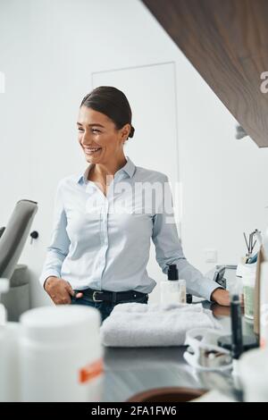 Merry beauty salon customer in casual clothes looking away Stock Photo