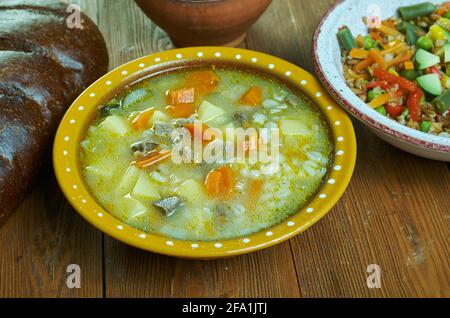 Krupnik zupa -  thick Polish soup made from vegetable or meat broth, containing potatoes and barley groats Stock Photo