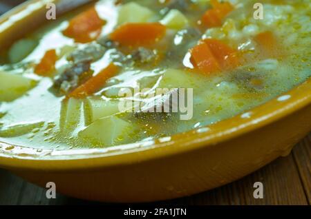 Krupnik zupa -  thick Polish soup made from vegetable or meat broth, containing potatoes and barley groats Stock Photo