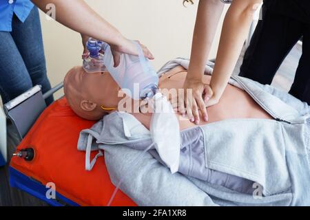 Nursing students learning how to rescue the patients in emergency. CPR training with CPR doll. Stock Photo