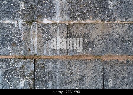 Old stone wall with structure of a garage. Background, texture, abstract. Stock Photo