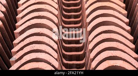 Pieces of terracotta roof stacked. Old type of roof used in ancient times. Horizontal view. Stock Photo