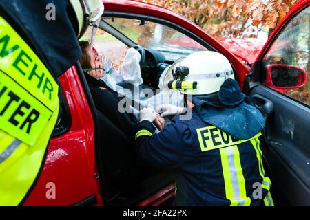 Accident - Fire brigade rescues accident Victim of a car, firefighter gives first aid Stock Photo