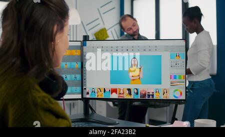 Freelancer retoucher woman working at computer with photo editing sofware using stylus pen while retouching client photo. Photographer designer processing digital image in post production app Stock Photo