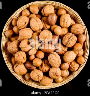 mixed nuts in a basket, hazelnuts, walnuts, almonds, pecans Stock Photo
