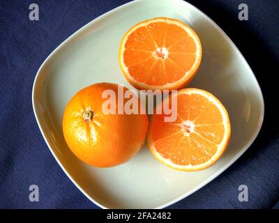 orange (Citrus sinensis), whole and halved fruit Stock Photo