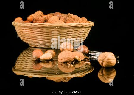 mixed nuts in a basket, nutcracker in the foreground Stock Photo