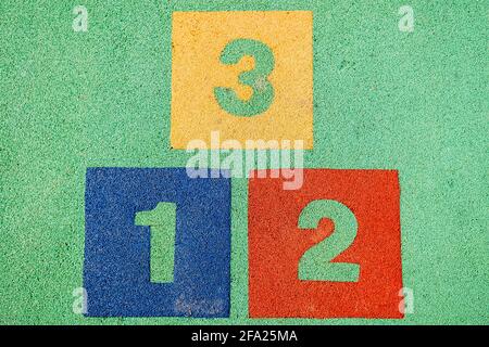 Blocks with the numbers one, two and three, positions on a podium on the floor. Stock Photo