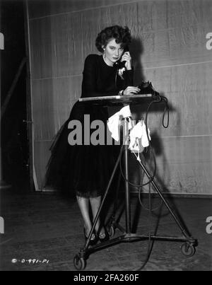 MARTA TOREN on set candid talking on telephone during break in filming of SIROCCO 1951 director CURTIS BERNHARDT  novel Joseph Kessel Santana Pictures Corporation / Columbia Pictures Stock Photo