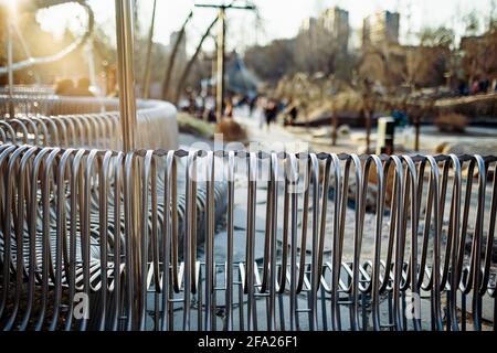 Close-up street bench metal pipes arranged parallel Stock Photo