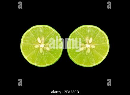 Pair of cross section fresh limes isolated s on black background Stock Photo