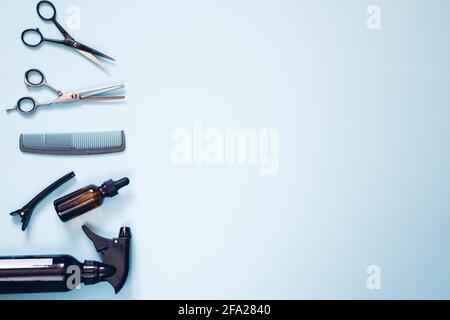 Set of professional hairdresser tools with combs and styling on blue background top view mock up Stock Photo