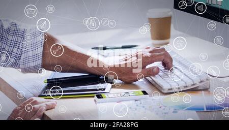 Composition of network of connections with digital icons over man typing on computer keyboard Stock Photo