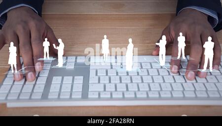 Composition of white people silhouettes over man using computer keyboard Stock Photo
