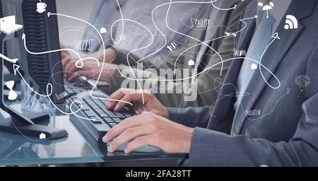 Composition of network of connections with digital icons over two businessmen using computers Stock Photo