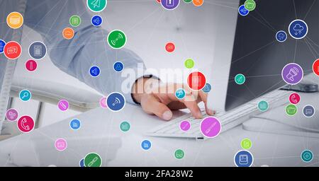 Composition of network of connections with digital icons over businessman using computer keyboard Stock Photo