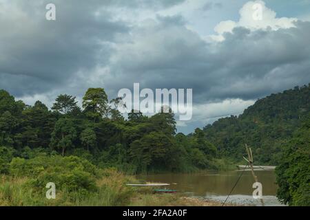 Landscape photograph of the Tembeling River and surrounding jungle, on a stormy day, in Malaysia National Park, also known as Taman Negara Malaysia, t Stock Photo