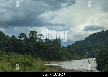 Landscape photograph of the Tembeling River and surrounding jungle, on a stormy day, in Malaysia National Park, also known as Taman Negara Malaysia, t Stock Photo