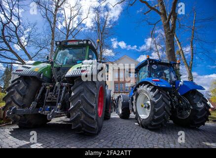 Schwerin, Germany. 22nd Apr, 2021. Tractors stand in the driveway of the Ministry of Agriculture during a protest action by farmers against the further spread of wild wolves. The Mecklenburg-Western Pomerania Farmers' Association has called for the demonstration in front of the Ministry of Agriculture at the beginning of the Conference of Environment Ministers. The farmers oppose a further growing wolf population and demand the reduction of the predators. Credit: Jens Büttner/dpa-Zentralbild/dpa/Alamy Live News Stock Photo