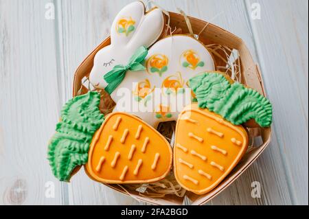 Sweets for celebrate Easter. Gingerbread in shape of easter bunny and carrot. homemade rabbit gingerbread sweet Stock Photo