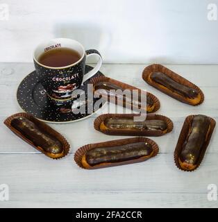 Gorgeous extra chocolate eclairs with gilded glaze Stock Photo