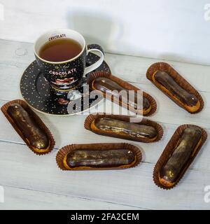 Gorgeous extra chocolate eclairs with gilded glaze Stock Photo