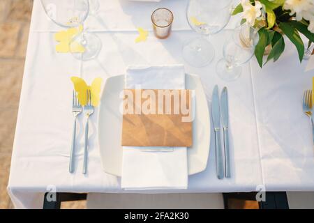 Blank card lies on a plate on a beautifully served table for dinner Stock Photo