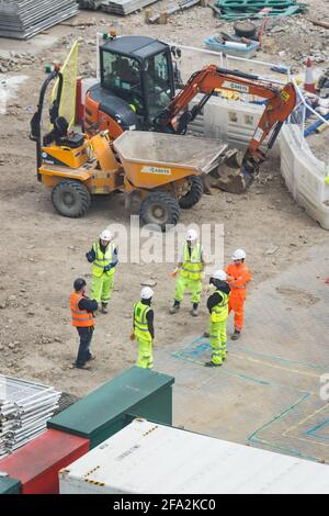 construction workers receiving hands-on training on site Stock Photo