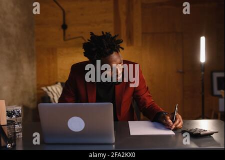 black business man working on laptop and taking notes Stock Photo