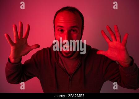Red Anger Explosion concept af angry and abusive man with red light. studio portrait of ...