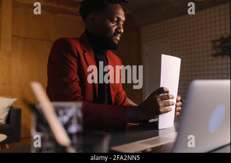 black business man working on laptop and taking notes Stock Photo