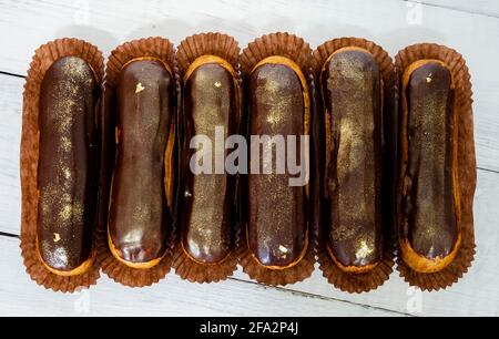 Gorgeous extra chocolate eclairs with gilded glaze Stock Photo
