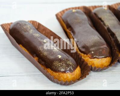 Gorgeous extra chocolate eclairs with gilded glaze Stock Photo