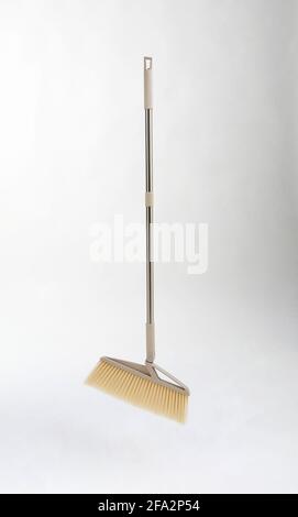 new broom with metal handle isolated on white background Stock Photo