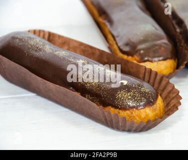 Gorgeous extra chocolate eclairs with gilded glaze Stock Photo